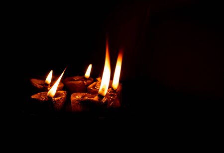 traditional religious soil made oil lamp many lightened for almighty godの写真素材