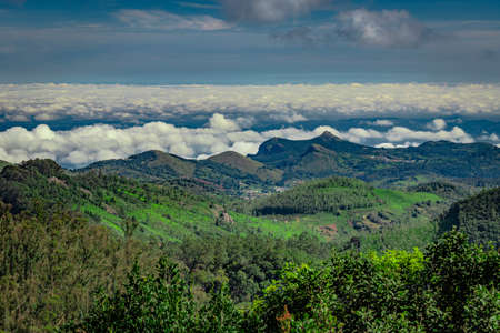 mountain range with cloud layers and green forest image is taken at south india. it is showing the beautiful landscape of south india.の写真素材
