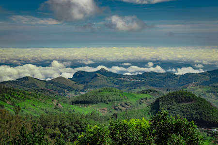 mountain range with cloud layers and green forest image is taken at south india. it is showing the beautiful landscape of south india.の写真素材