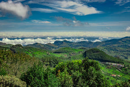 mountain range with cloud layers and green forest image is taken at south india. it is showing the beautiful landscape of south india.の写真素材