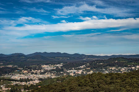 city view with mountain range and bright blue sky from hill top at day image is taken from doddabetta peak ooty india. it is showing the bird eye view of ooty city with mountain range in background.の写真素材
