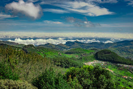 mountain range with cloud layers and green forest image is taken at south india. it is showing the beautiful landscape of south india.の写真素材
