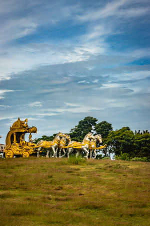 holly Arjuna chariot of Mahabharata in golden color with amazing sky background image is taken at murdeshwar karnataka india.の写真素材