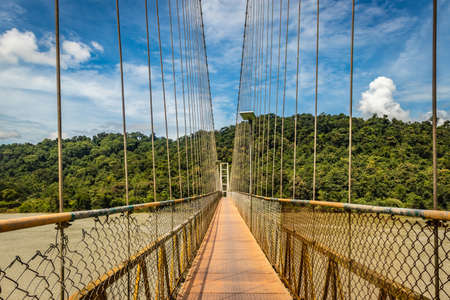 suspension iron cable bridge isolated with bright blue sky from unique different angle image is taken at honnavar karnataka india. it is the fine example of modern engineering.の写真素材