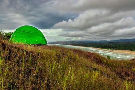 camping solo at mountain top with amazing view and dramatic sky image is taken at gokarna karnataka india.の写真素材