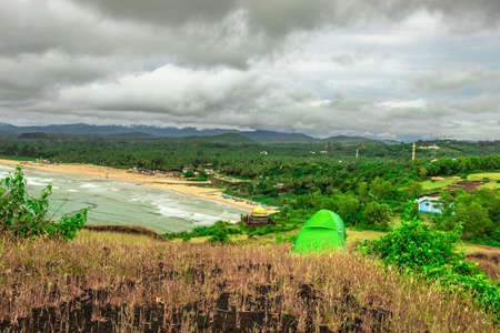camping solo at mountain top with amazing view and dramatic sky image is taken at gokarna karnataka india.の写真素材