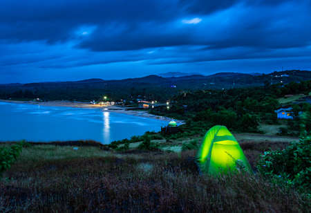 camping solo at mountain top with amazing view and dramatic sky at evening image is taken at gokarna karnataka india.の写真素材