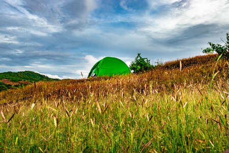 camping solo at mountain top with clouded sky image is taken at gokarna karnataka india.の写真素材