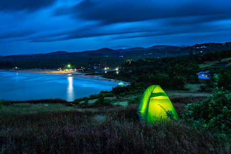 camping solo at mountain top with amazing view and dramatic sky at evening image is taken at gokarna karnataka india.の写真素材