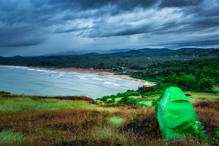 camping solo at mountain top with amazing view and dramatic sky at evening image is taken at gokarna karnataka india.の写真素材