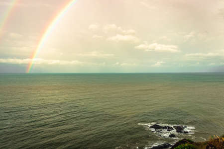 rainbow colorful above sea horizon at dawn image is taken at gokarna karnataka india. it is showing the colorful art of nature.の写真素材