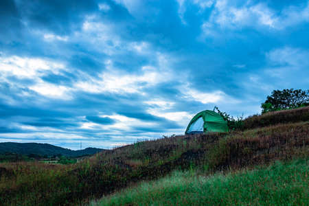 camping solo at mountain top with amazing view and dramatic sky at evening image is taken at gokarna karnataka india.の写真素材