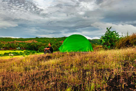 camping solo at mountain top with amazing view and dramatic sky at evening image is taken at gokarna karnataka india.の写真素材