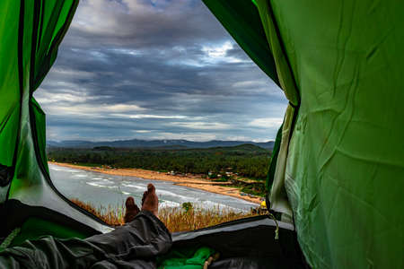 man at camping tent inside view of amazing landscape sea shore image is taken at gokarna karnataka india. it is showing the human love towards the nature.の写真素材
