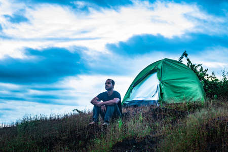 camping solo at mountain top with amazing view and dramatic sky at evening image is taken at gokarna karnataka india.の写真素材