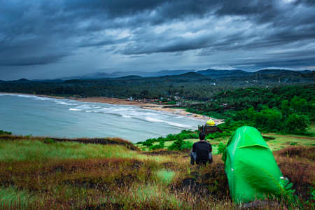 camping solo at mountain top with amazing view and dramatic sky at evening image is taken at gokarna karnataka india.の写真素材