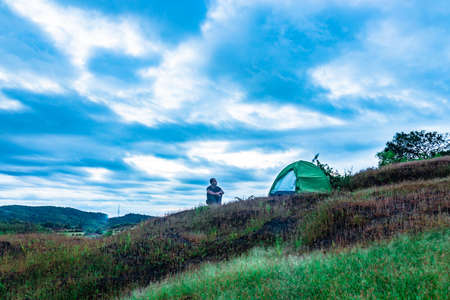 camping solo at mountain top with amazing view and dramatic sky at evening image is taken at gokarna karnataka india.の写真素材