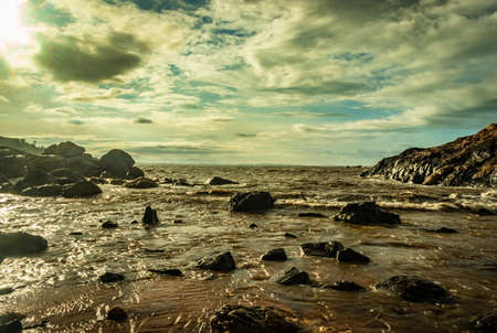 rocky sea beach with crashing waves at morning from flat angle image is taken at om beach gokarna karnataka india. it is one the best beach of gokarna.の写真素材