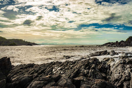 rocky sea beach with crashing waves at morning from flat angle image is taken at om beach gokarna karnataka india. it is one the best beach of gokarna.の写真素材