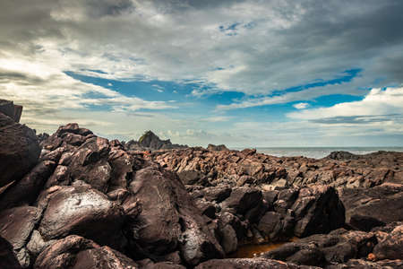 natural rock formation at sea shore due to crashing waves at morning from flat angle image is taken at om beach gokarna karnataka india. it is one the best beach of gokarna.の写真素材