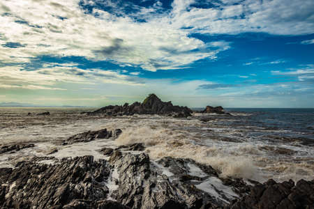 rocky sea beach with crashing waves at morning from flat angle image is taken at om beach gokarna karnataka india. it is one the best beach of gokarna.の写真素材