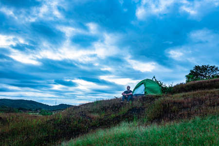 camping solo at mountain top with amazing view and dramatic sky at evening image is taken at gokarna karnataka india.の写真素材