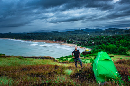 camping solo at mountain top with amazing view and dramatic sky at evening image is taken at gokarna karnataka india.の写真素材
