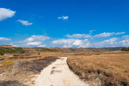 countryside fields with leading line of white sand bright and blue sky at morning from flat angle image taken on sohra fall meghalaya india.の写真素材