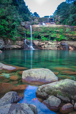 natural waterfall clear view with water stream falling from mountain at green forests at morning image is taken at lyngksiar falls cherrapunjee meghalaya india.の写真素材