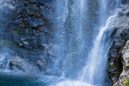 waterfall falling streams through rocks in forest at morning from flat angle image is taken at thangsning fall shillong meghalaya india.の写真素材
