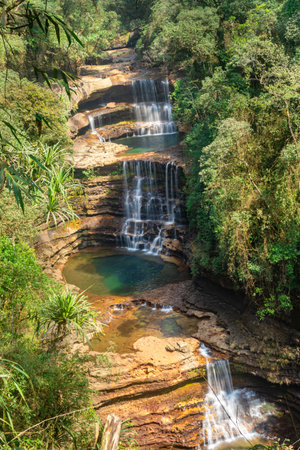 natural waterfall layered falling from mountain top in deep green forests at morning from top angle image is taken at wei sawdong falls cherrapunji sohra district meghalaya india.の写真素材