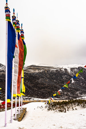 holy buddhist flag at war memorial with snow cap mountains in the background image is taken at...