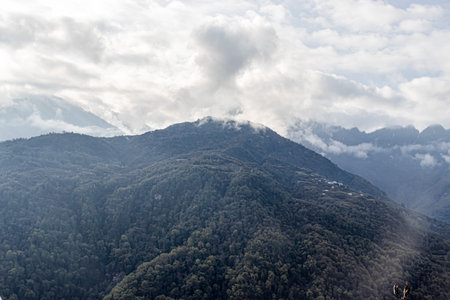 mountain range covered with dense cloud at morning from flat angle image is taken at sela pass tawang india.の写真素材