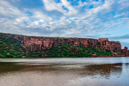 lake pristine with mountain background and bright sky at morning image is showing the beauty of Bhutanatha Temple on the shores of Agastya Tirtha at Badami karnataka india.の写真素材