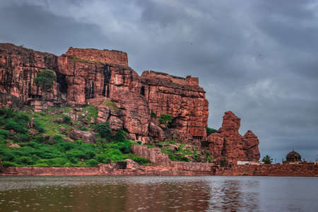 mountain with cloudy sky at dusk from flat angle image is showing the beauty of Bhutanatha Temple on the shores of Agastya Tirtha at Badami karnataka india.の写真素材