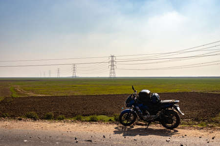 motorcycle parked on road low angle image is taken at Koshi bridge saharasa bihar india on Feb 11 2020. It is the serene beauty of bihar.の写真素材