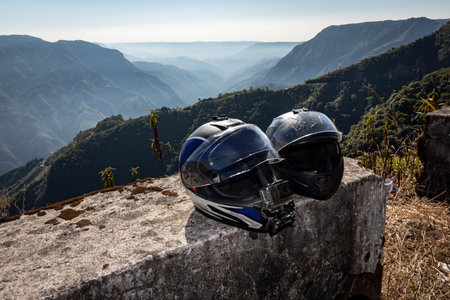 helmets of couple rider at mountain range covered with white mist