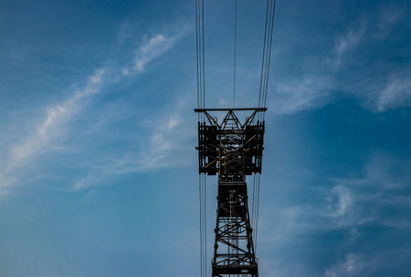 electric power transmission line with bright blue sky background
