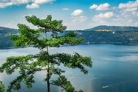 lake serene blue water with misty mountains aerial image is taken at umiam lake shillong meghalaya india. it is showing the breathtaking beauty of nature.の写真素材