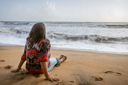 girl soaking up the natural sea view and fresh breeze on the coast image is taken at kochi kerala india showing the feeling of an girl in the true nature.の写真素材