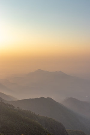 Sunrise view of Hill Range in orange rays Image taken at Kodaikanal tamilnadu India from top of the hill. Image is showing the beautiful nature.の写真素材