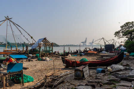 Fisherman and its Fishing nets in the morning hours at kochi kerala costのeditorial素材