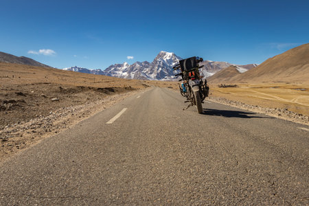 isolated biker motorcycle on picturesque tarmac road in himalaya mountain image is taken at on the way to Gurudongmar lake north sikkim india. it is one of the highest motorable road india.のeditorial素材