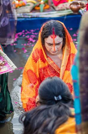 devotee praying for sun god during Chhath festival from flat angle