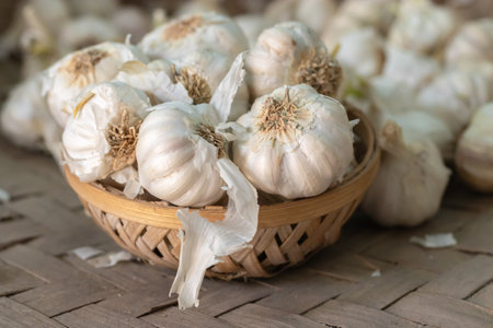 fresh garlic from farm in bamboo bowl from top angle at dayの写真素材