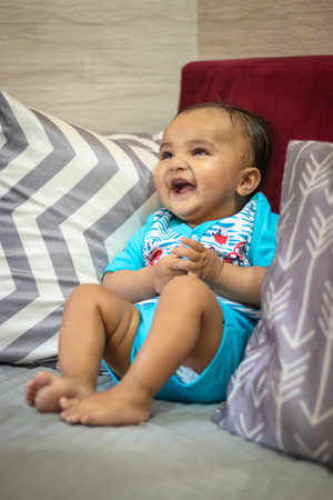 cute infant facial expressing from top angle indoor shotの写真素材