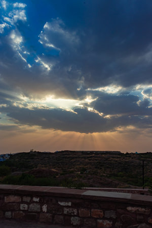 sunrise dramatic sky with sun beams with dark clouds at dawnの写真素材