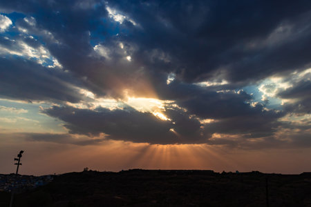 sunrise dramatic sky with sun beams with dark clouds at dawn