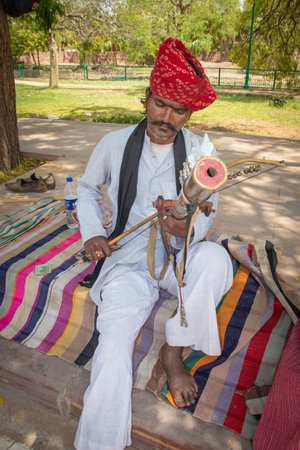 man playing traditional musical instrument in authentic local dress at street of india at morning image is taken jodhpur rajasthan india on Apr 11 2023.のeditorial素材