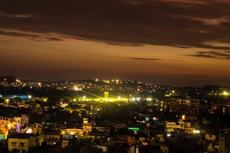 city night light view with dramatic sunset orange sky from mountain top at evening image is taken at ganesh temple jodhpur rajasthan india.の写真素材